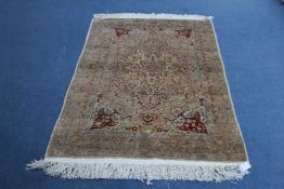 A small 20th century part silk Turkish rug, the central lozenge shape medallion with repeating