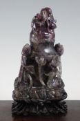 A large Chinese amethyst quartz vase and cover, of flattened baluster form, carved in high relief