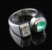 A stylish modern 18ct white gold emerald and diamond three stone dress ring, set with emerald and