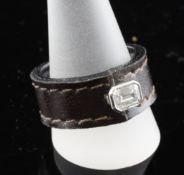 An unusual emerald cut diamond set leather ring. Starting Price: £240