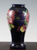 A Moorcroft `Clematis` baluster vase, c.1925, on cobalt blue ground, inscribed `W Moorcroft` mark,