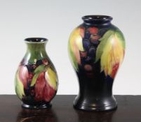 A Moorcroft `Leaf and Berry` inverted baluster small vase and a small baluster vase; the former c.