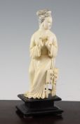 A Chinese ivory seated figure of a lady, early 20th century, her hands posed to play a flute, now