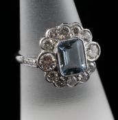 An 18ct white gold, aquamarine and diamond set cluster ring, with diamond set shoulders, the total