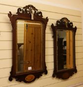 A pair of George III style parcel gilt and mahogany fretted wall mirrors, each with a ho-ho bird