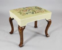 A Queen Anne walnut stool, with later tapestry seat, on carved cabriole legs with square pad feet,