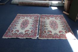 A pair of Indian rugs, with floral decoration on a cream ground, 4ft 11in by 3ft. Starting Price: £