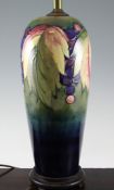 A Moorcroft `Leaf and Berry` tall lamp, on graduated blue to green ground, mounted on wooden base,