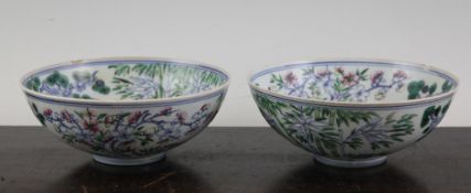 A pair of Chinese Wucai bowls, Republic period, each with a rice grain window decorated with the