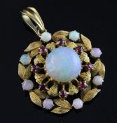 A 20th century gold, ruby and opal set pendant, of circular foliate design, 1in. Starting Price: £