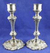 A pair of early Victorian silver candlesticks, of waisted form, with foliate scroll decoration and