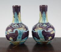 A pair of Japanese enamelled pottery bottle vases, early 20th century, each decorated in