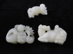 Three Chinese white jade figures, comprising a boy with ducks amid lotus, 2.2in. a monkey on a