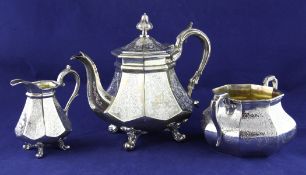 A Victorian silver matched three-piece tea set, of tapering octagonal form, with foliate engraved