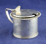 A George V silver drum mustard, with gadrooned border and shell thumbpiece, Tessiers Ltd, London,