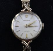 A lady`s 9ct gold Rolex precision wrist watch, with baton numerals, case back inscription and X-