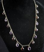 A late Victorian silver gilt amethyst and garnet fringe necklace, set with alternating stones, 15.