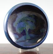 A Moorcroft `Moonlit Blue` shallow bowl, c.1925, on powder blue ground, inscribed `W Moorcroft`