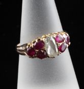 An early 20th century gold, seven stone ruby and diamond cluster dress ring, size O. Starting Price: