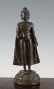 A South East Asian bronze standing figure of Buddha, on a lotus base, 14.5in. Starting Price: £80