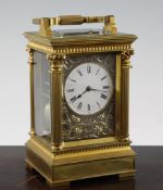 An Edwardian gilt brass quarter repeating carriage clock, with ornate corinthian case, enamelled