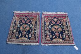 A pair of Iranian prayer mats, decorated with vase of flowers flanked by birds and pillars, on a