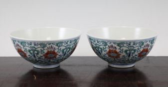 A pair of Chinese doucai bowls, Daoguang seal marks but later, each painted with lotus blossoms