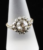 An antique gold and rose cut diamond cluster ring, with engraved shank and pierced shoulders, size