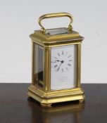 A late 19th century French ormolu miniature carriage timepiece, with enamelled Roman dial signed E W