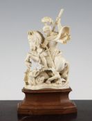 An early 20th century carved ivory figure of St George and the Dragon, on a shaped hardwood base,