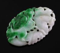 A 19th century jadeite carving, in later brooch mount, of oval form, with floral carving, 1.5in.