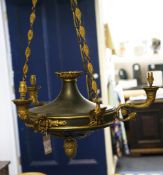 A French Empire style gilt brass and ebonised ceiling light, with three scrolling cornucopia