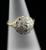 An 18ct gold and platinum diamond cluster target ring, size J. Starting Price: £200