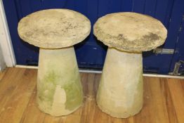 A pair of reconstituted staddle stones, with circular tops and tapered bases, H.2ft 4in. Starting
