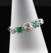 A platinum, five stone emerald and diamond set ring, size O. Starting Price: £240