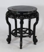 A late Victorian circular ebonised jardiniere stand, by Wylie & Lochhead in the Chinese manner, with
