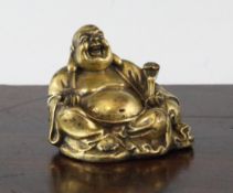A Chinese gilt bronze `Budai` scroll weight, 18th century, modelled in seated pose, holding a ruyi