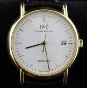A gentleman`s 18ct gold IWC Portofino automatic dress wrist watch, with baton numerals and date
