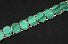 A Russian 14ct gold and malachite bracelet, set with nine oval malachite plaques, 7in.