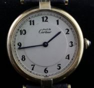 A lady`s silver gilt must de Cartier quartz wrist watch, with Arabic dial and cabochon sapphire