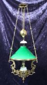 A Victorian brass adjustable hanging ceiling light, with green shade and winged griffin uprights,