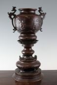 A Japanese brown patinated bronze pedestal vase, or koro, c.1900, cast in relief with figures and