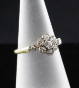An 18ct gold and platinum set diamond cluster ring, of flowerhead design, with diamond set