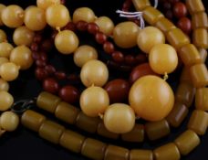 Three reconstituted amber bead necklaces, of varying colours and shapes, 26in et infra.