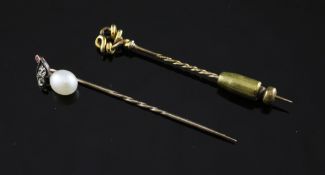 A gold, ruby and cultured pearl set stick pin, 2.25in and one other stick pin with scroll terminal.