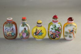 Five Chinese enamelled opaque white glass snuff bottles, decorated with figures, birds and a