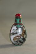 A Chinese two colour overlaid and enamelled glass snuff bottle, decorated with river landscape