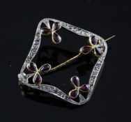 A Belle Epoque style 18ct gold, ruby and diamond set brooch, of square open form with foliate