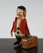 A Schuco tinplate `clown with a suitcase` clockwork toy, 4.5in.