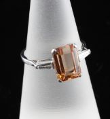 An 18ct white gold, diamond and pink topaz ring, with trapeze cut diamond shoulders and emerald